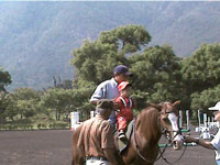 Child and adult riding horse